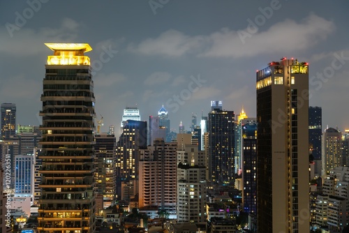 Night skyline of Bangkok with illuminated buildings showcasing urban life and architecture