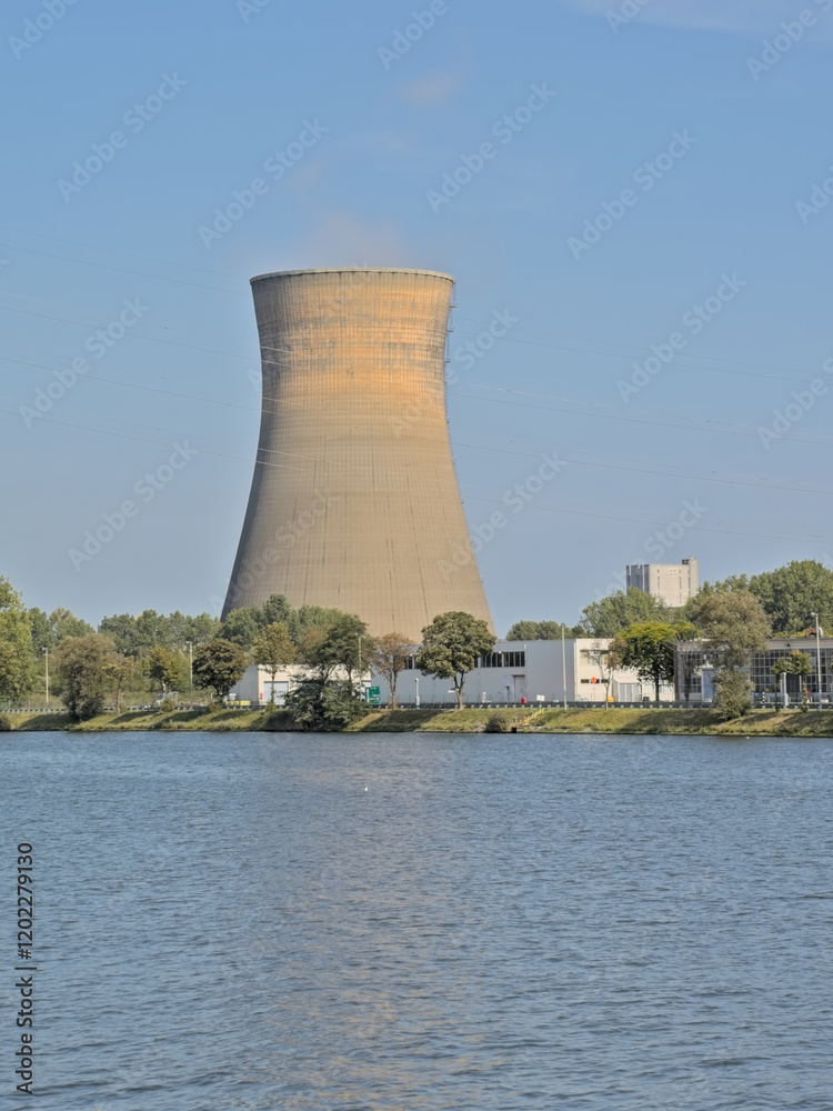 Cooling tower surrounded by trees in the harbor of Ghent, Flanders, Belgium 