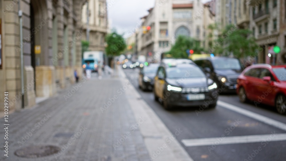 Barcelona street view with bokeh effect showing blurred cars driving along defocused urban outdoor scene, capturing vibrant european city atmosphere. Barcelona street view with bokeh effect showing blurred cars driving along defocused urban outdoor scene, capturing vibrant european city atmosphere.