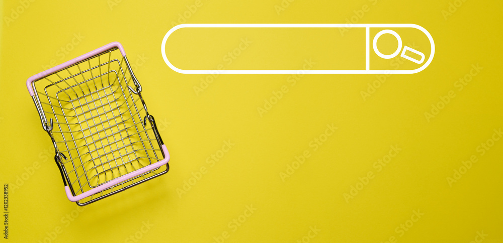 Empty miniature shopping cart on yellow background, top view