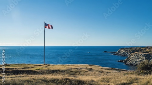 America flag soaring on a flagpole with a vast blue ocean in the distance