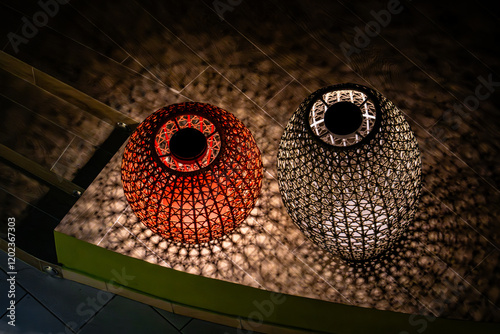 Two lanterns, one red and one black, are lit up photo