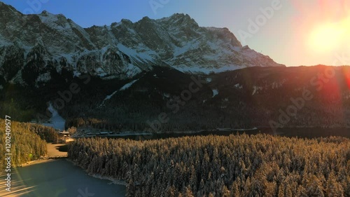 Breathtaking aerial view over snow-covered treetops in Germanys Bavarian Alps, showcasing Zugspitze massif. Zugspitze Gipfel highest peak of Wetterstein Mountains and highest mountain in Germany.  photo