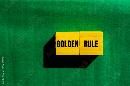 Golden rule message written on yellow wooden cubes with green background. Conceptual golden rule symbol. Copy space.