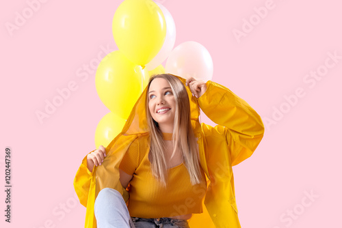 Young woman in raincoat wit...