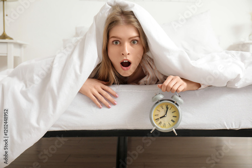 Shocked young woman holding...