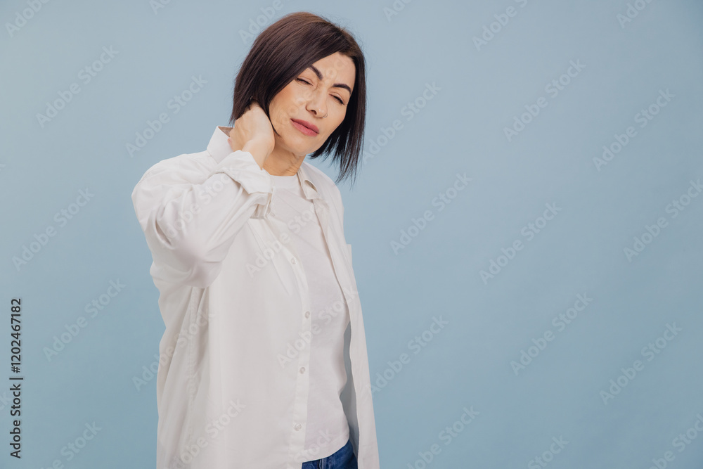 Brunette Woman Suffering Neck Pain on Blue Background Brunette Woman Suffering Neck Pain on Blue Background