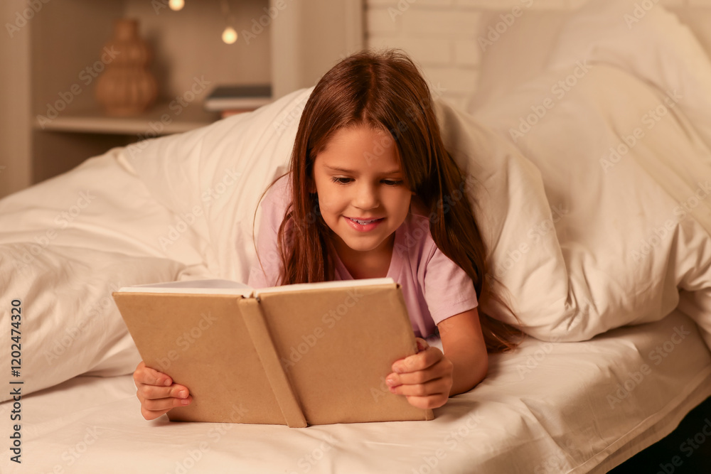 Cute little girl reading bedtime story in bed at home Cute little girl reading bedtime story in bed at home