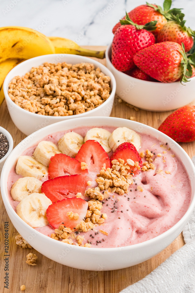 Smoothie bowl on a wooden board with bowls of granola and fresh fruit Smoothie bowl on a wooden board with bowls of granola and fresh fruit