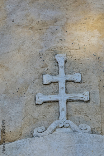 USA, California, Carmel. Inside the grounds at the Carmel Mission Basilica Museum cross against wall photo