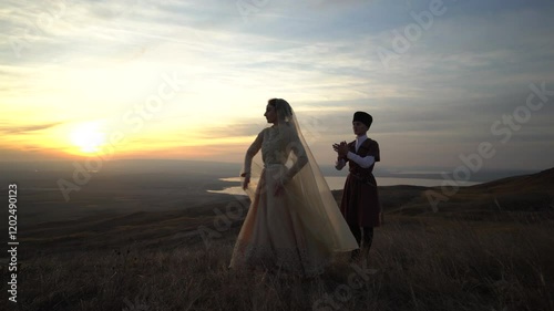 couple in traditional costumes dancing national dance on the background of nature