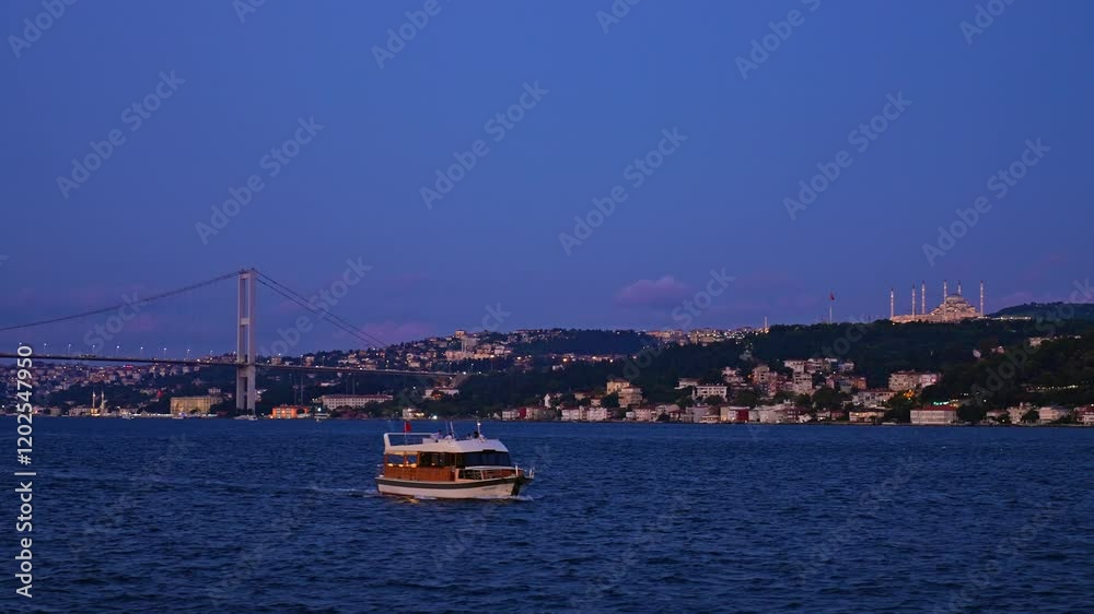 This video captures a serene evening view of Istanbul's coastline, with warm lights reflecting on the Bosphorus. Historic buildings and vibrant streets shine showcasing the city's charm. This video captures a serene evening view of Istanbul's coastline, with warm lights reflecting on the Bosphorus. Historic buildings and vibrant streets shine showcasing the city's charm.