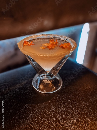 Lychee Martini with a sugar rim in a dark bar. 