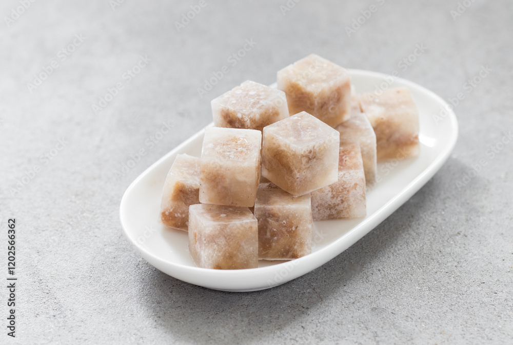 Aspic. Jellied meat in the shape of a mini cubes. On a plate. Close up Aspic. Jellied meat in the shape of a mini cubes. On a plate. Close up