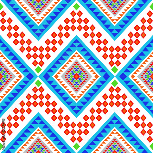 Vibrant Native American geometric pattern with dynamic zigzags in white, terracotta, and blue. Features diamond centerpieces with tribal triangular details and rust-red checkerboard accents designs.
