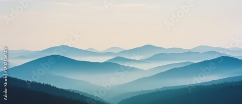 Mist drapes over rolling blue mountains, creating layers of serene beauty that dissolve into a tranquil, endless horizon.