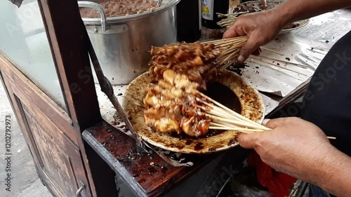 Chicken Satay Mix with Seasoning Sauce on a Plate