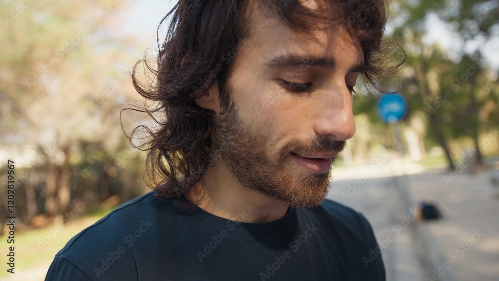 Young Sad Long Hair Man Reads A Book In The Park Outdoors Young Sad Long Hair Man Reads A Book In The Park Outdoors