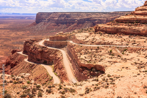 A desert road with a cliff in the background photo