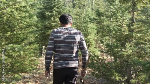 Lumberjack walking in forest