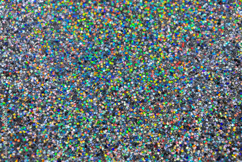 Full frame macro abstract texture background of a sparkling multi color confetti glitter surface
