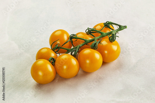 Yellow sweet tomato on the branch