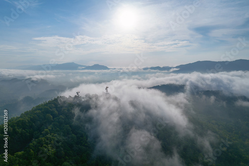 Aerial view fog in the forest and mountains and the transmission towers. Repeater station. photo