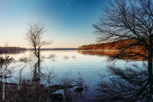 Canvas Print Still water at sunrise with reflection on water