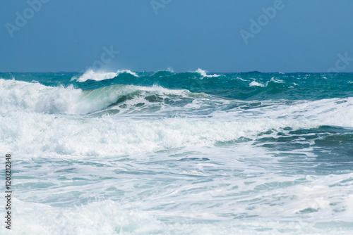Obraz na płótnie Waves on the beach in windy day. Blue sea and the blue sky. w salonie