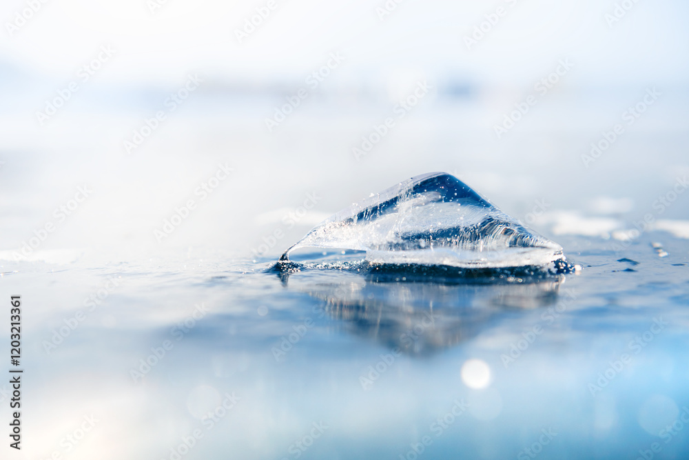 Beautiful ice floe on the transparent blue ice on the frozen lake.