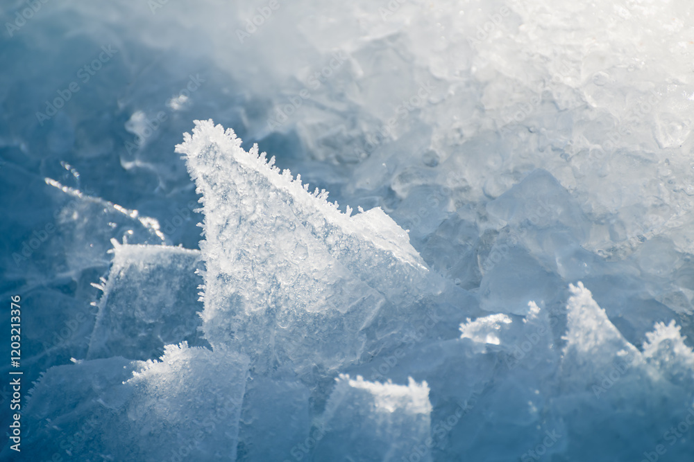 Ice floes with ice crystals on the frozen lake in winter. Macro image.