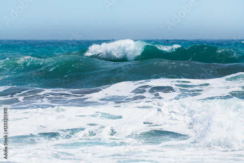 Obraz na płótnie Waves on the beach in windy day. Blue sea and the blue sky. w salonie