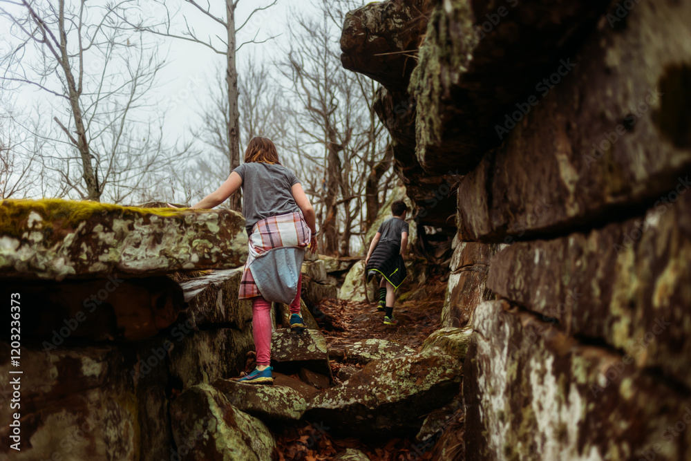 Children hiking on rocks on overcast day Children hiking on rocks on overcast day