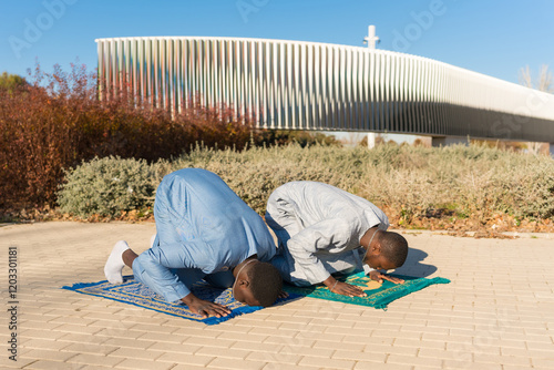 Photography Two senegalese men praying outdoors during ramadan