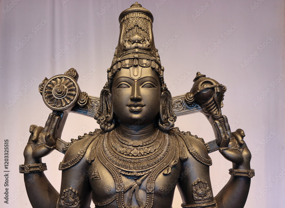 Fototapeta premium A Fine art Sculpture of Lord Venkateshwara or Balaji, in detail, carved in black stone, worshipped in Tirupati pilgrimage, Andra Pradesh, India.