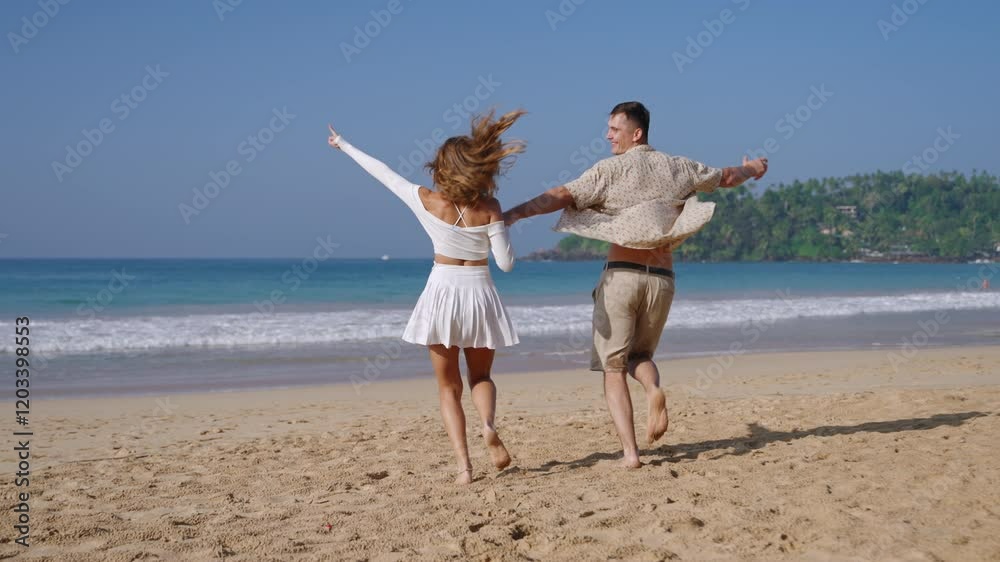 Attractive couple run holding hands in sea surf waves. Tanned man and woman having fun on summer vacation at the sandy beach. Boyfriend, girlfriend enjoying romantic date at ocean shore. Attractive couple run holding hands in sea surf waves. Tanned man and woman having fun on summer vacation at the sandy beach. Boyfriend, girlfriend enjoying romantic date at ocean shore.