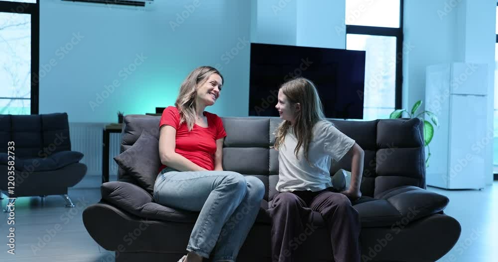 Loving little daughter presents bonbons box to happy mother at home. Smiling child prepares sweet surprise to parent for special event slow motion