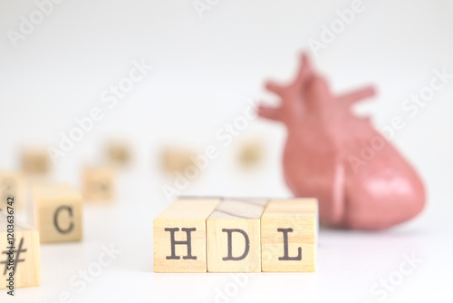 High-density lipoprotein acronym. HDL written on wooden cubes isolated with a heart on white background. Concept of cholesterol 