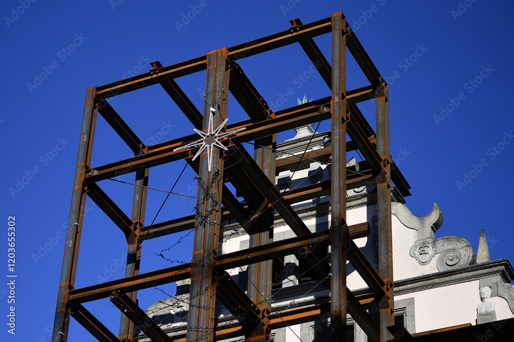 Steel scaffolding with a poinsettia on an old wall of a listed building Steel scaffolding with a poinsettia on an old wall of a listed building
