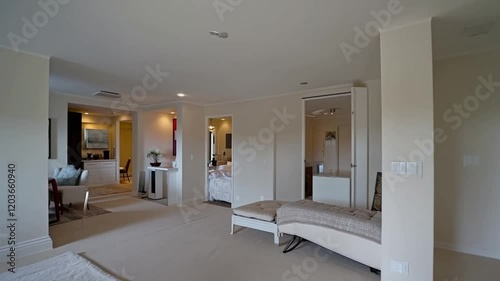 Bright and airy apartment interior with white tones, showcasing sleek design and minimalist decor.