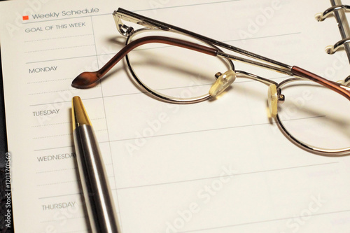 Dear manager's notebook, pen and glasses lie on financial documents and banknotes photo