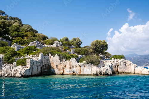 Fototapeta Naklejka Na Ścianę i Meble -  Sunken Lycian town view on Kekova island near Kas, Antalya district, Turkiye. The Kekova region is steeped in history, with ruins of ancient settlements around every corner. The turquoise water 