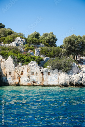 Sunken Lycian town view on Kekova island near Kas, Antalya district, Turkiye. The Kekova region is steeped in history, with ruins of ancient settlements around every corner. The turquoise water  photo