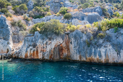 Fototapeta Naklejka Na Ścianę i Meble -  Sunken Lycian town view on Kekova island near Kas, Antalya district, Turkiye. The Kekova region is steeped in history, with ruins of ancient settlements around every corner. The turquoise water 
