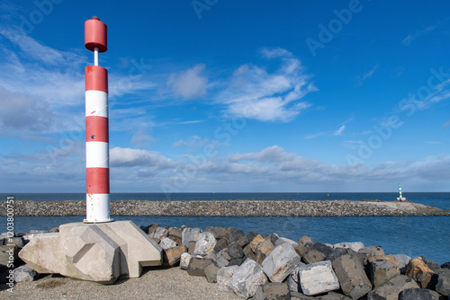 Port of escape on former Breezand working island on Afsluitdijk (dam separates IJsselmeer lake from Wadden Sea), the Netherlands  against a white clouded blue sky photo