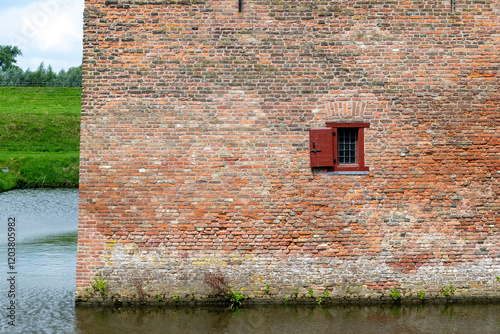 Part of wall with window of Medieval Loevestein Castle (Slot Loevestein) in Zaltbommel, the Netherlands built between 1357 and 1397 former part of Dutch Waterline, the main Dutch flooding defense line photo