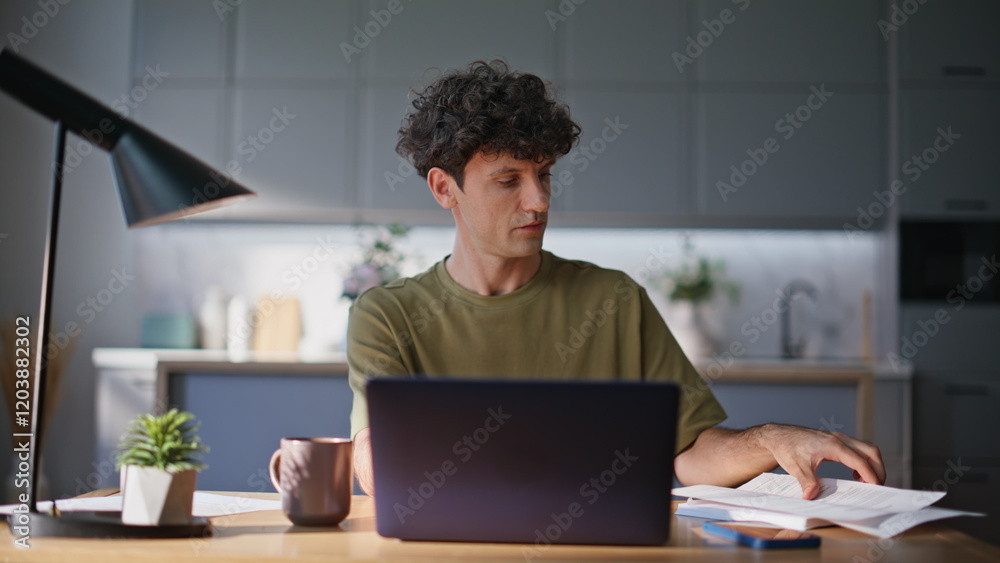 Busy employee focusing paperwork solving laptop task at home interior closeup Busy employee focusing paperwork solving laptop task at home interior closeup