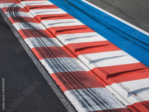 Red and White Racing Curb Close-Up at a Race Track photo