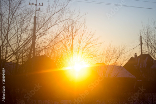 Sunset over the village. Beautiful winter landscape in the village.
