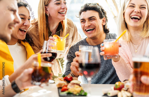 Multiracial friends celebrating party drinking cocktails at bar restaurant - Young people having fun hanging out on weekend day - Life style concept with guys and girls enjoying time together